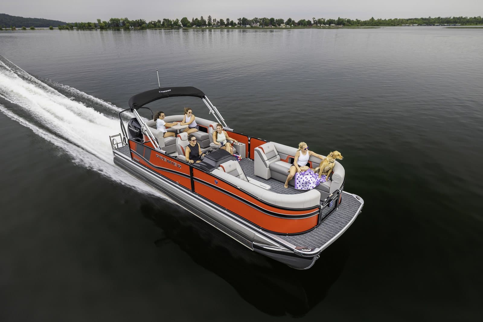 A Premier Marine pontoon cruising on a calm Minnesota lake